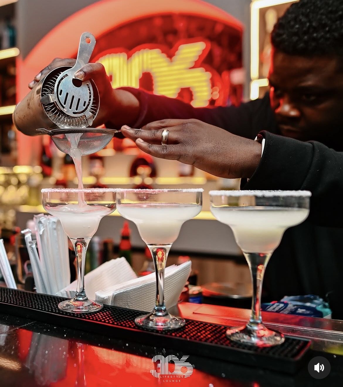 Bartender straining fresh margaritas at the 306 bar