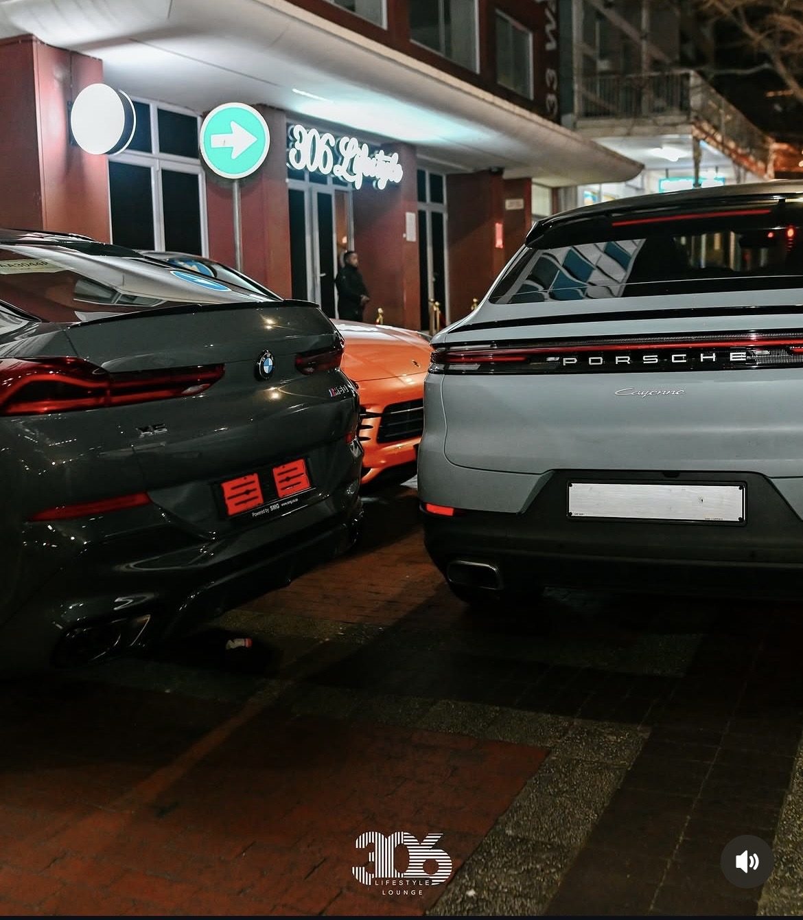 Cars parked outside 306 Lifestyle Lounge at night
