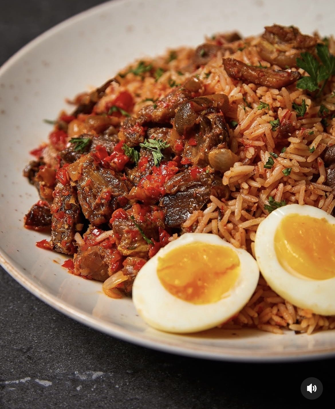 Spiced jollof rice with braised lamb and soft-boiled egg